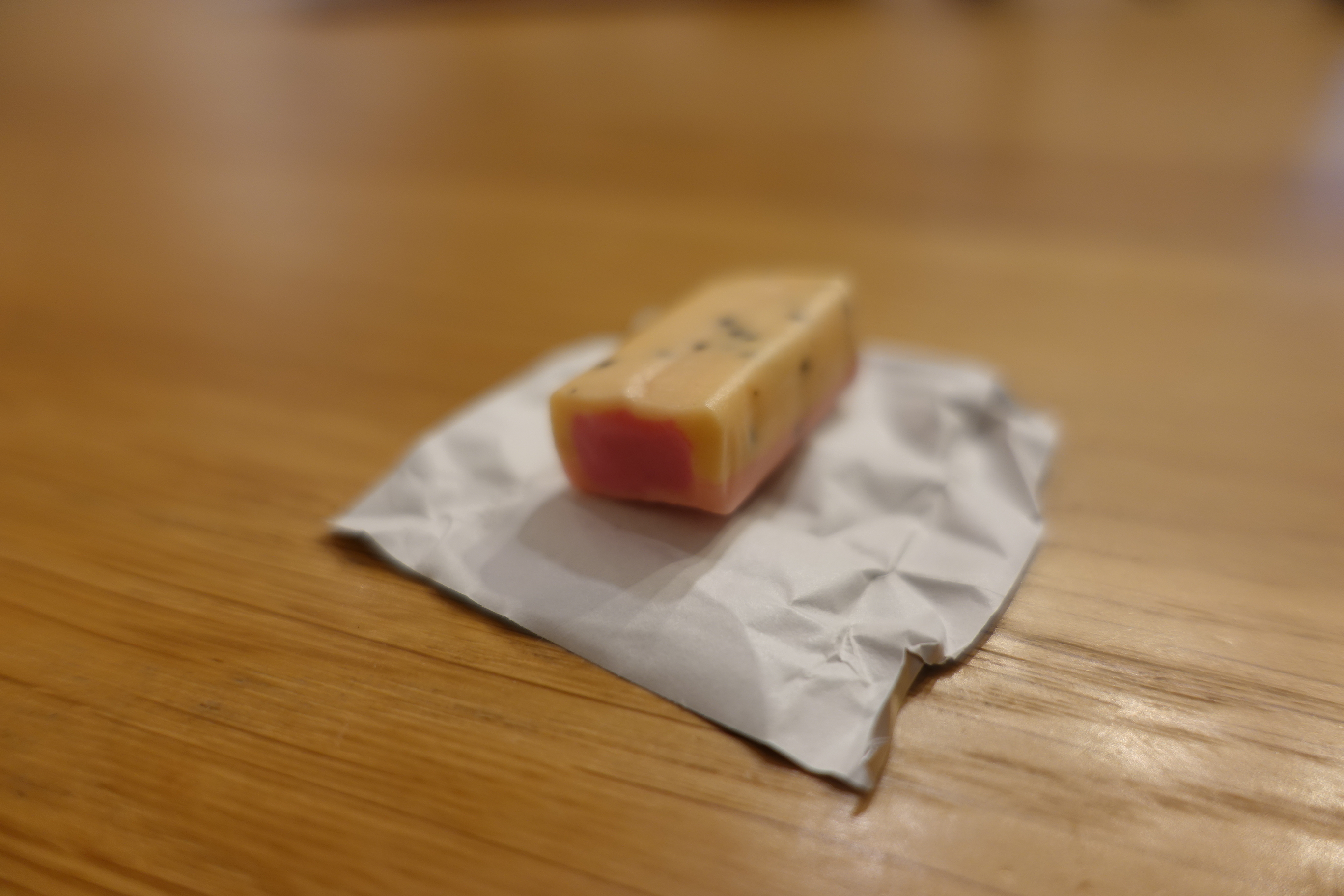 Passion fruit Hi-Chew, showing the seed-like texture inside