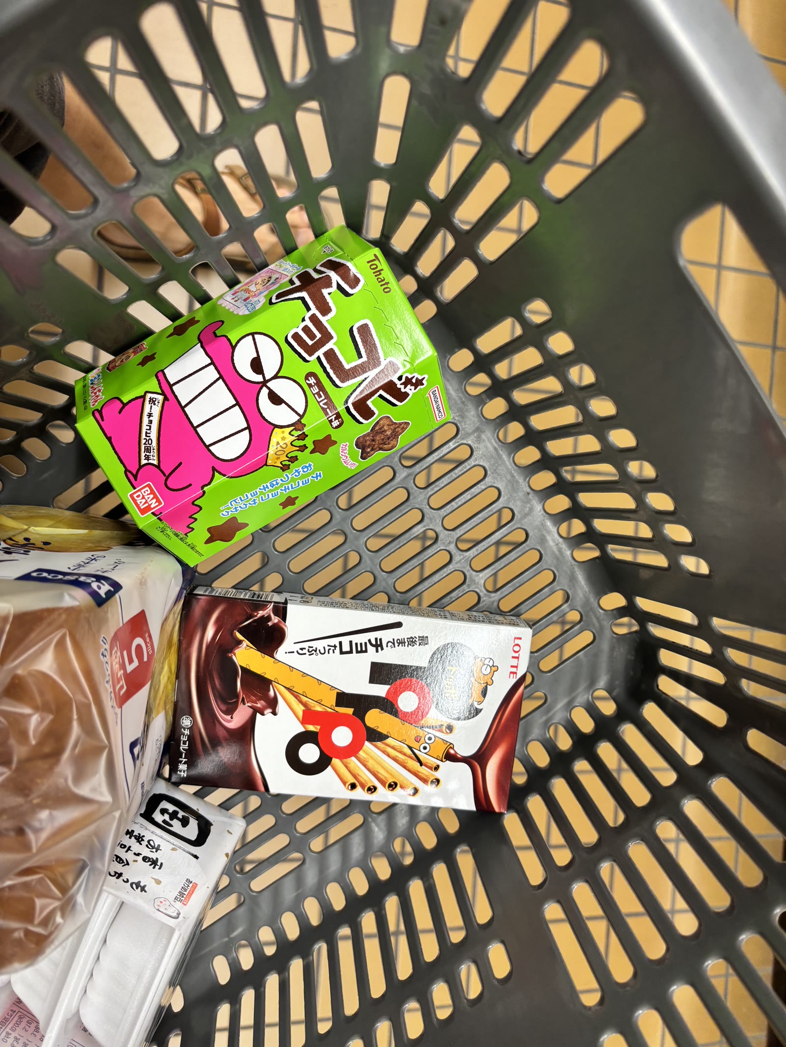 Toppo in a shopping basket next to other Japanese snacks